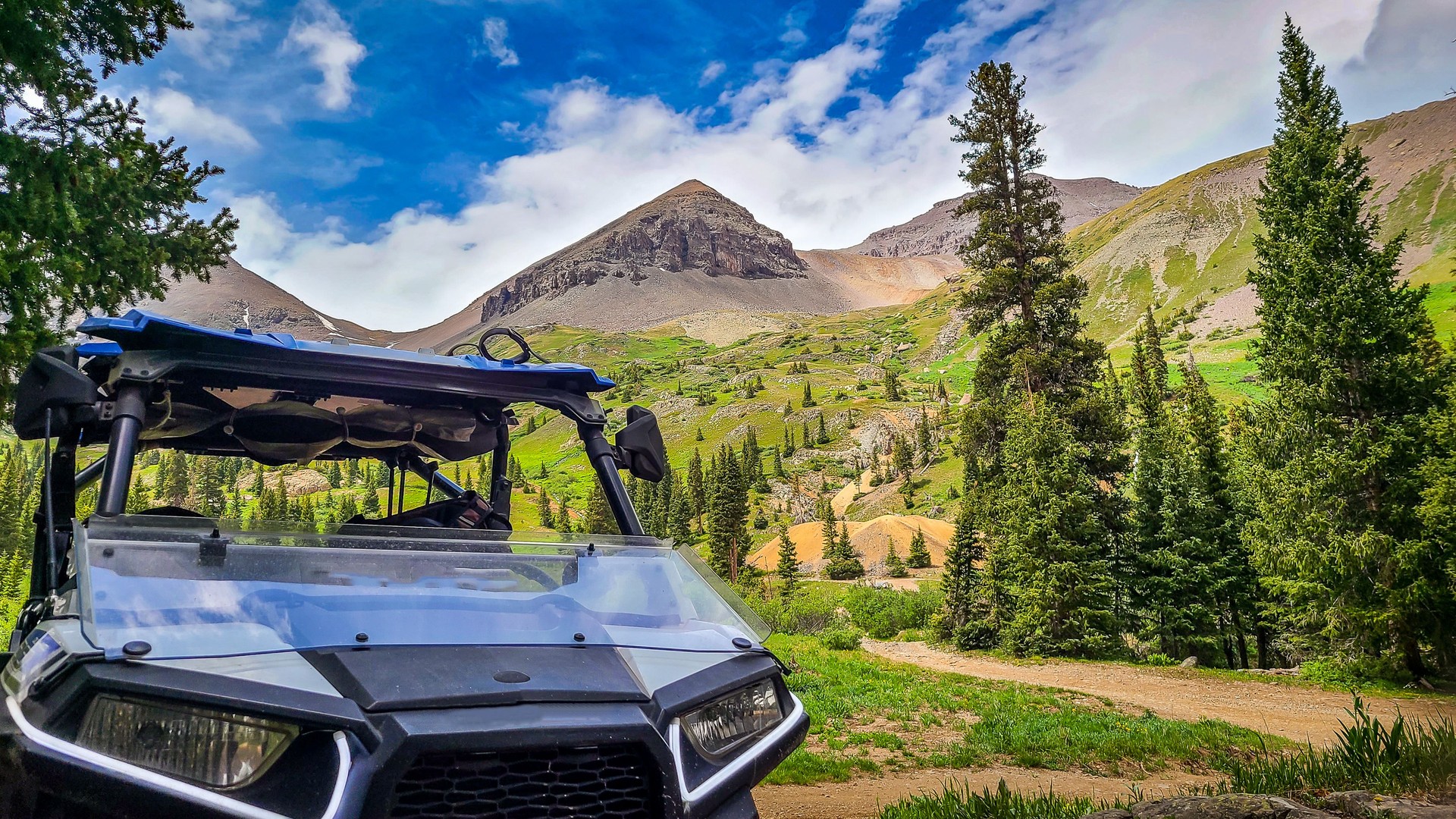 Side by side UTV ATV RZR with Mountain range in the background along the Yankee Boy Basin trail near Silverton and Ouray Colorado in the San Juan Mountains, Rocky Mountains Colorado.