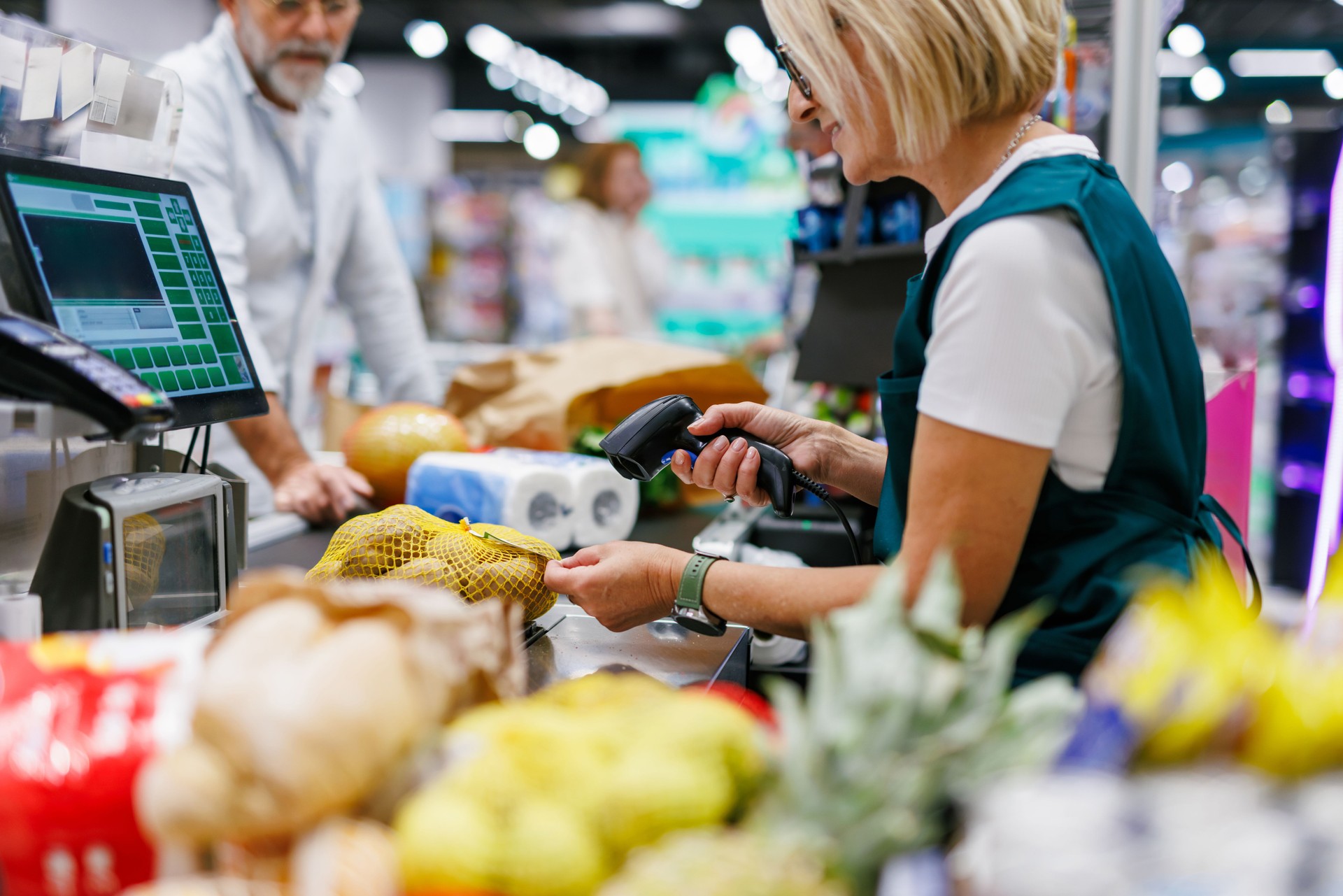 Cashier scanning groceries at the supermarket checkout