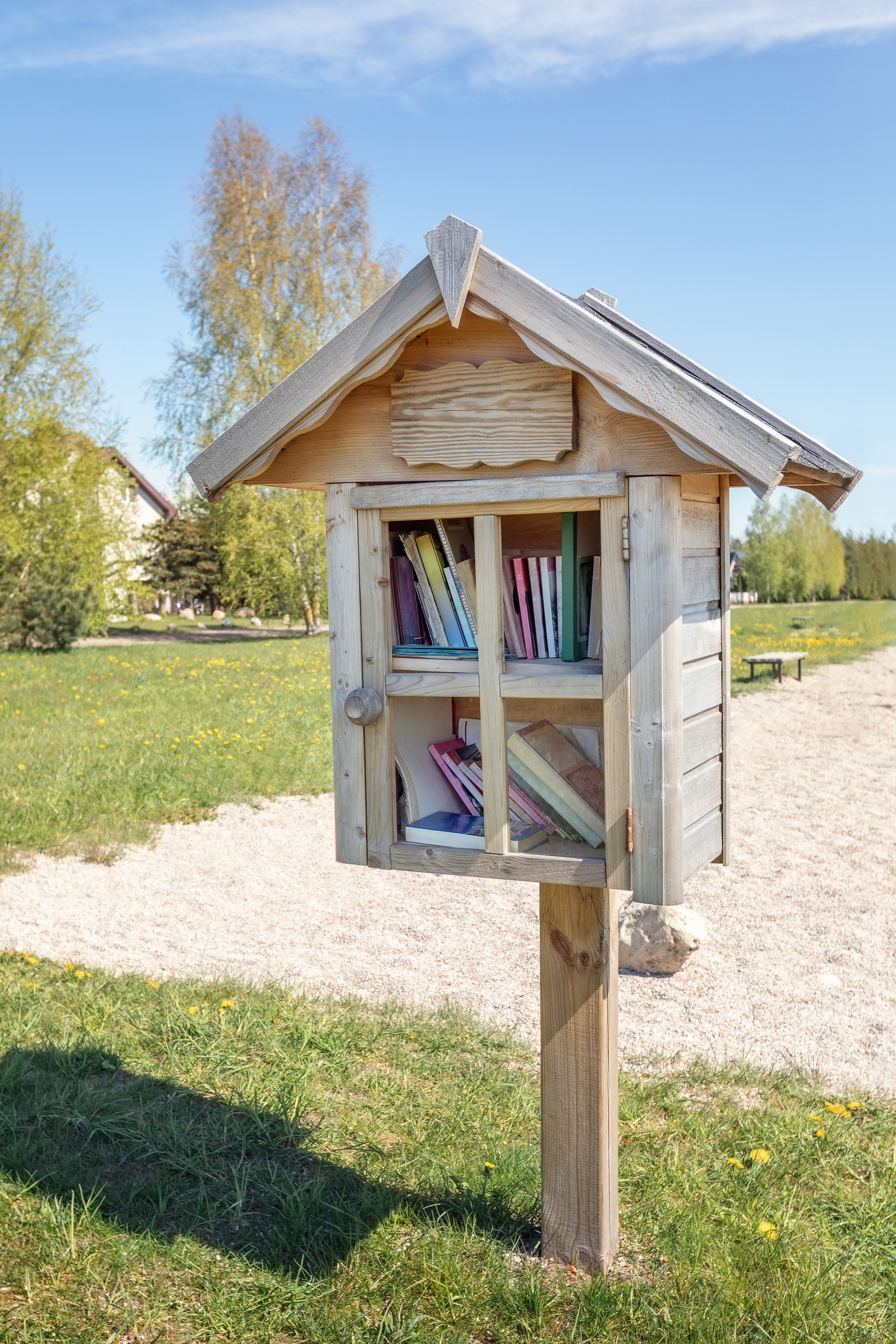 Outdoor free book sharing mini house. Book sharing box located in community park.